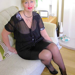 Slutwife wearing a Tight Shiny knee length skirt with a suspender belt and Shiny Nylon Stockings and High Heels